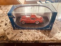 Front three-quarter view of boxed red 1949 Jaguar XK120 model