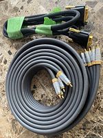 Coiled Philips RCA cable and two braided multi-pin cables showing length and connectors