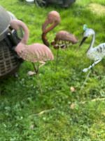 All three metal garden bird ornaments standing in grass