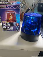 Beacon light next to its retail box