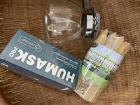 Basket containing glass coffee carafe, Humask mask box, bamboo stakes bundle