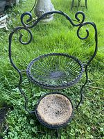 Front view showing two circular baskets and scrollwork frame