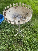 Full view of wrought iron plant holder showing bowl, rim, and base