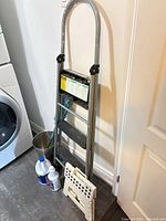 Full lot: folded 3-step ladder, step stool, waste bin, mop and cleaning bottles