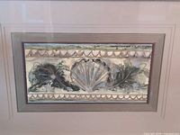 Close view of artwork showing seashell motif and mat detail