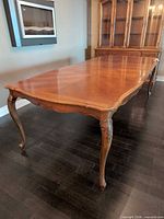 Full view of extendable table showing length and cabriole legs