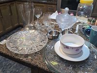 Overview of all serveware, glassware, stainless pieces, porcelain bowl