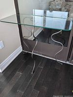 Full view of glass top table against wall