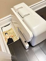 Sewing machine with hard cover and paperwork