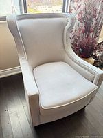 Front and side view of light gray wingback armchair