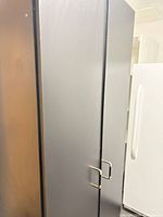 Full view of cabinet front beside white appliance