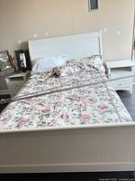 Full view of assembled queen bed showing headboard, footboard, side rails and bedding (bedding not included)