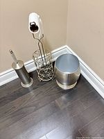 All three silver metal bathroom accessories grouped together