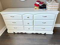 Front view of white 9-drawer dresser