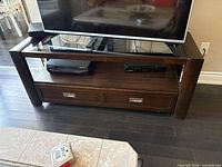 Full front view of wood and glass TV stand