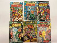Six Adventure Comics issues laid out front covers visible