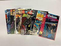 All nine comics fanned out showing front covers
