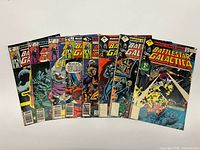 All eight comics fanned out showing front covers and issue numbers