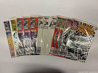 Twelve bagged Alpha Flight comics fanned out