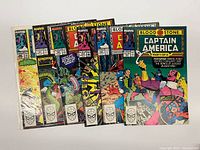 Front covers of all six bagged issues spread out