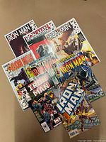 All nine Iron Man comics fanned out showing covers and titles