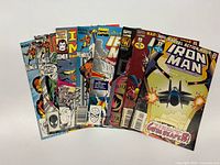 Front view of all eight Iron Man comics fanned out