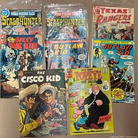 All eight comics laid out; titles and issue numbers visible