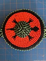 Front view of round beaded turtle medallion