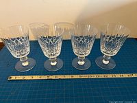 Front view four crystal goblets with ruler for scale