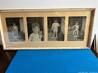 Front view showing four portraits, mat and frame