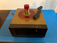 Overall view showing cabinet, spindle, speaker grille and missing logo