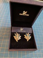 Silver-tone leaf clip earrings in Swarovski presentation box