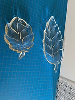 Both leaf-shaped glass dishes top view on cutting mat