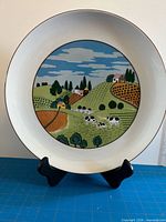 Front view showing complete landscape design and stand