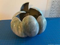 Three angles of the ceramic planter showing overall form and glaze