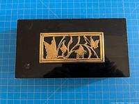 Top view showing black finish and gold butterfly floral panel