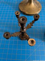 Top view of miniature five-light brass candelabra, partial candlestick base