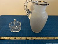 Pitcher and basket beside ruler for scale