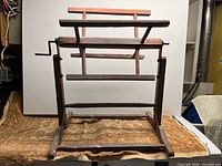 Full front view of wooden yarn swift showing overall structure and crank