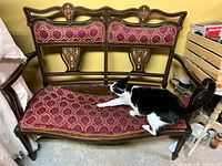 Front view of settee showing frame, upholstery, and marquetry details
