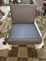 Front view of gray leather armchair showing seat, back and frame