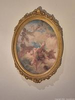 Full view of framed oval artwork on wall