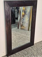 Full view of rectangular mirror with dark wood frame