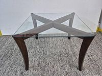 Full view of table showing glass top and wood legs