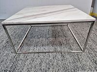 Full view of marble coffee table showing steel base