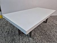 Perspective view showing table thickness and leg design