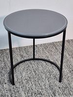 Full view of assembled round side table on carpet