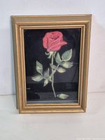 frontal view of framed paper tole rose artwork