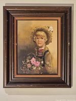 Framed oil portrait painting of child with flowers