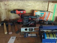 Shelf with cordless drill, Craftsman jigsaw, belt sander, mallets, level, blades and lubricant can
